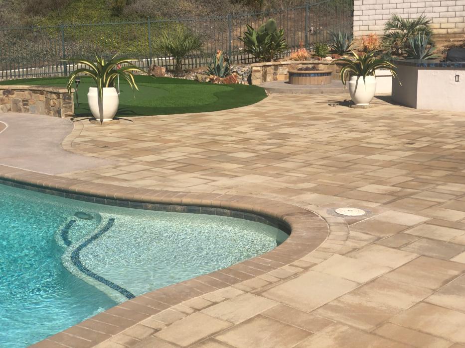 Outdoor pool area showcasing concrete pavers and slip-resistant pool deck.