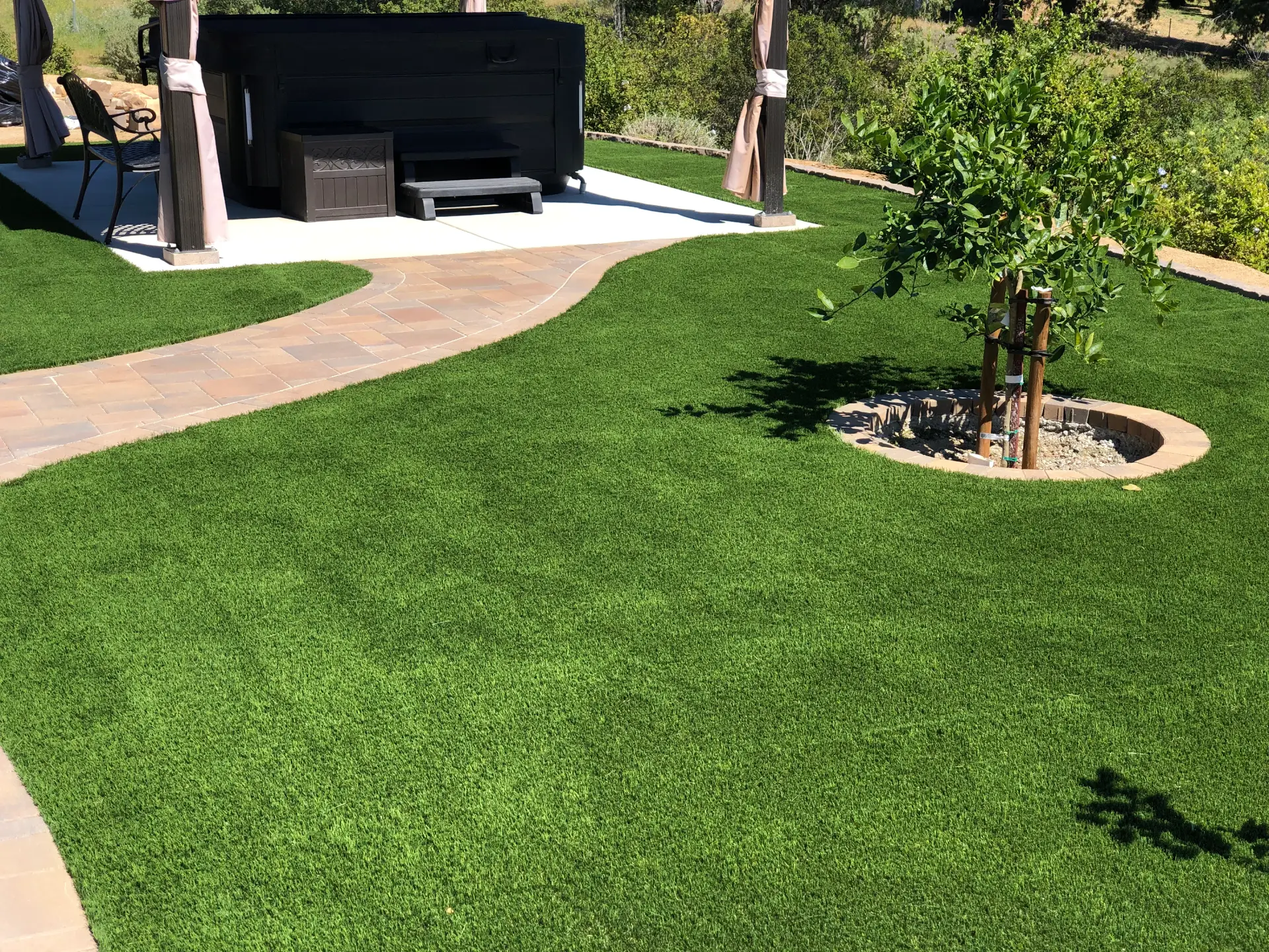 Artificial Turf next to pathway with concrete pavers